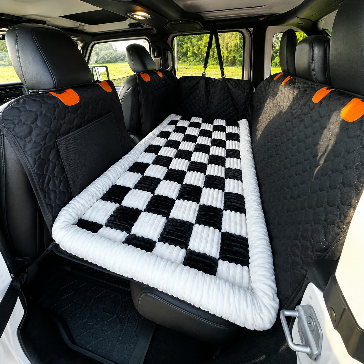 Black and white checkerboard Luxe Dog Bed laid across a back seat