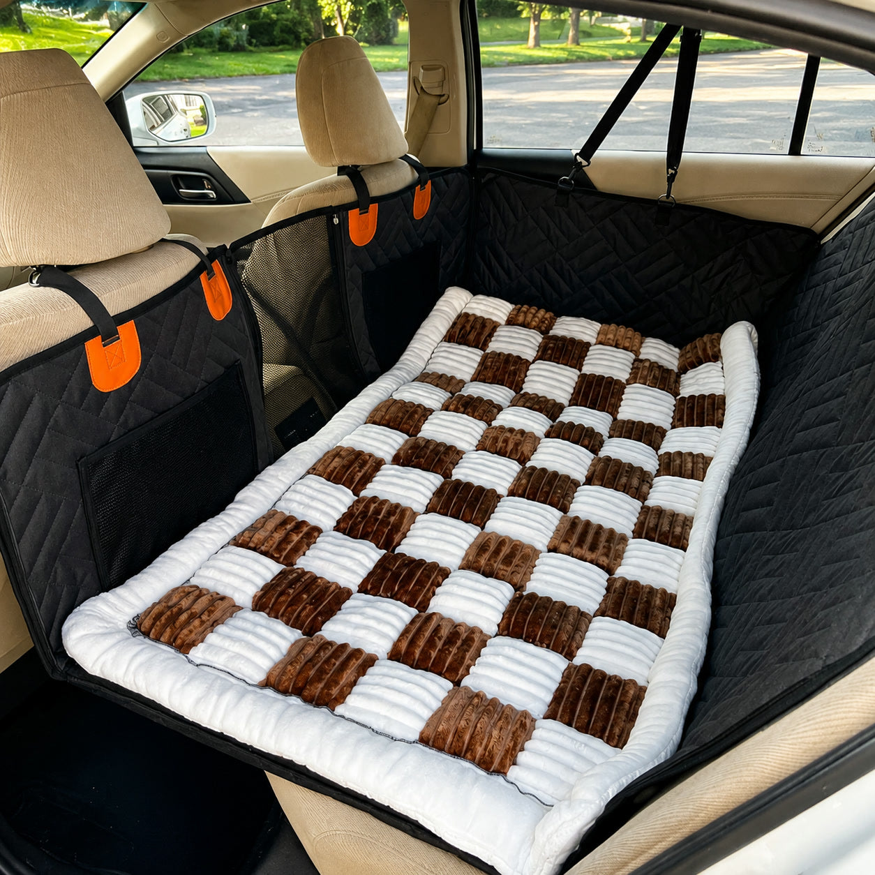 Brown checkerboard Luxe Dog Bed on a car back seat
