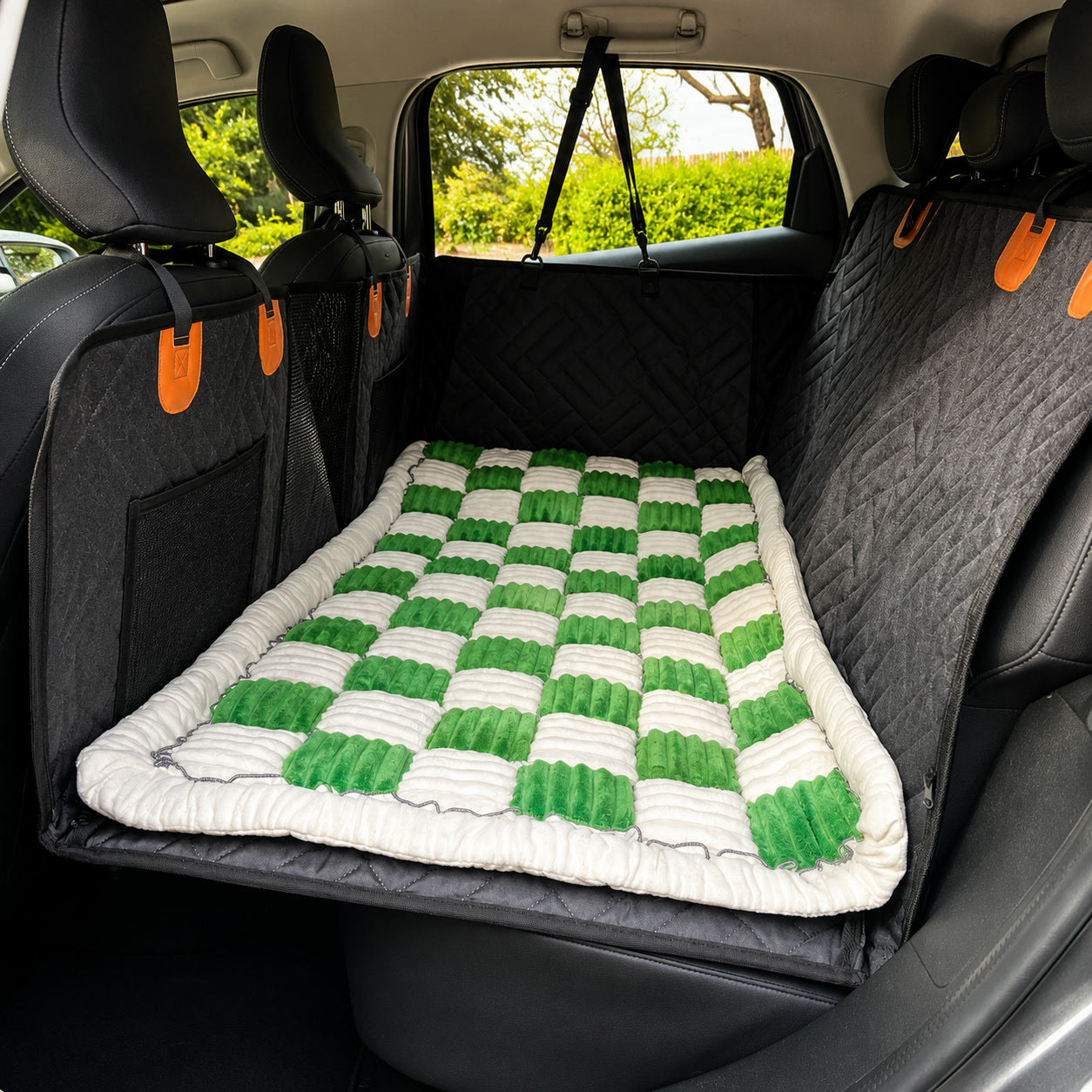 Green checkerboard Luxe Dog Bed on a car back seat