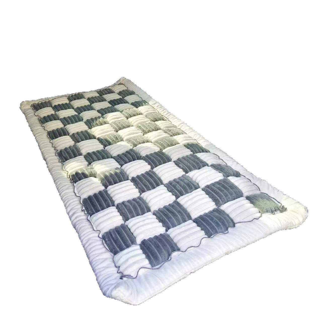 The Luxe Dog Bed on a plain background, showing the quilted plush surface