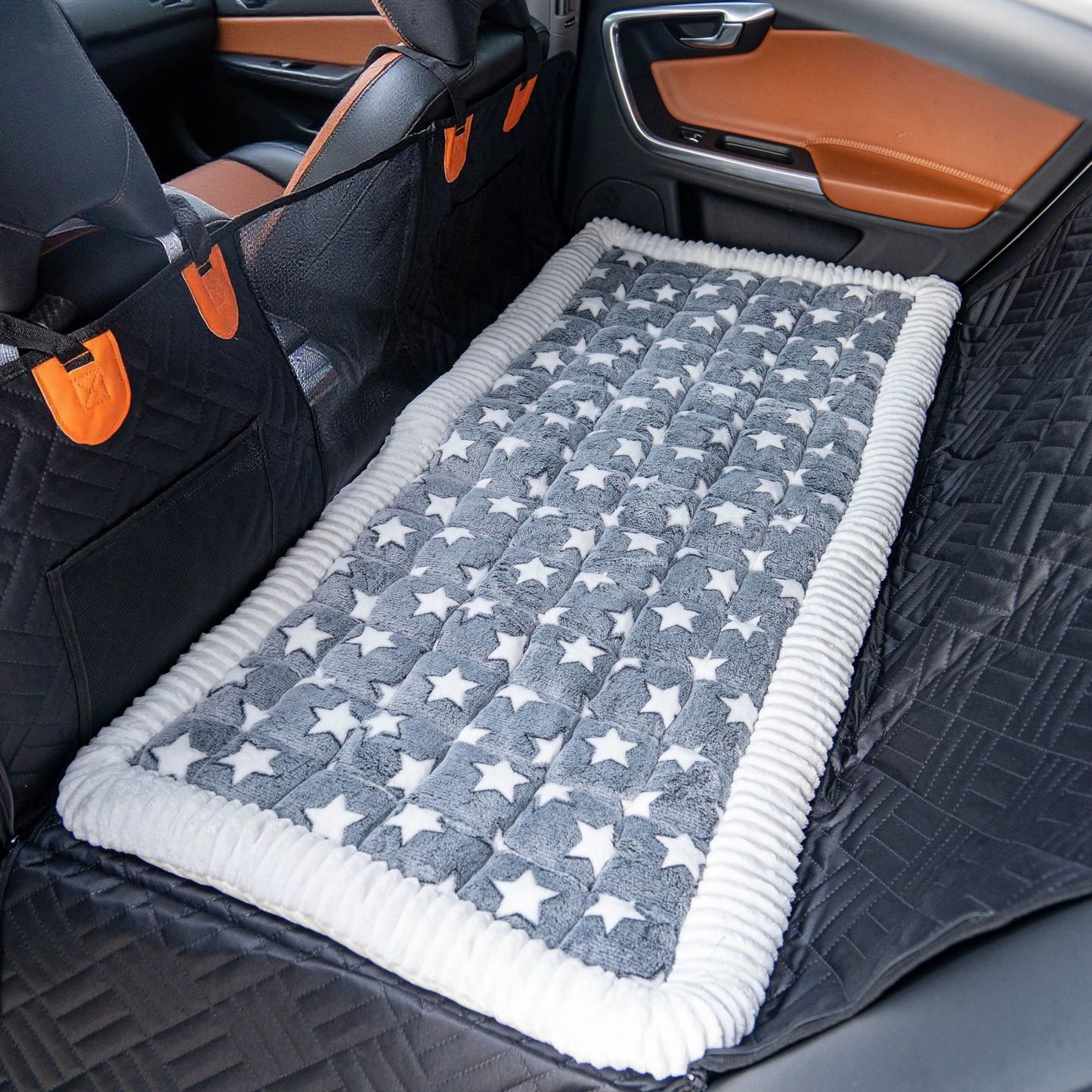 Gray star-pattern version of the Luxe Dog Bed on a back seat